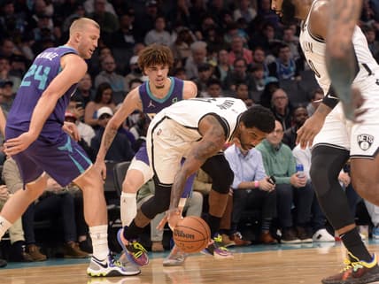 Mar 8, 2022; Charlotte, North Carolina, USA;  Brooklyn Nets guard Kyrie Irving (11) moves past Charlotte Hornets center Mason Plumlee (24) during the first half at the Spectrum Center. Mandatory Credit: Sam Sharpe-USA TODAY Sports