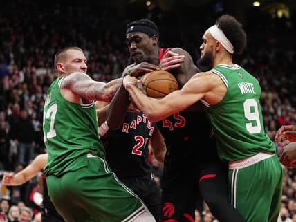 Mar 28, 2022; Toronto, Ontario, CAN; Toronto Raptors forward Pascal Siakam (43) grabs a rebound from Boston Celtics center Daniel Theis (27) and guard Derrick White (9) during the overtime at Scotiabank Arena. Mandatory Credit: John E. Sokolowski-USA TODAY Sports