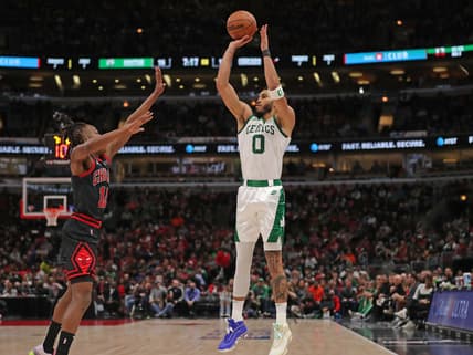 Apr 6, 2022; Chicago, Illinois, USA;Boston Celtics forward Jayson Tatum (0) shoots over Chicago Bulls guard Ayo Dosunmu (12)  during the first quarter at the United Center. Mandatory Credit: Dennis Wierzbicki-USA TODAY Sports