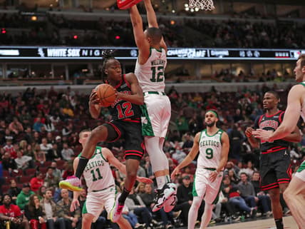 Apr 6, 2022; Chicago, Illinois, USA; Chicago Bulls guard Ayo Dosunmu (12) passes round Boston Celtics forward Grant Williams (12) during the second half at the United Center. Mandatory Credit: Dennis Wierzbicki-USA TODAY Sports