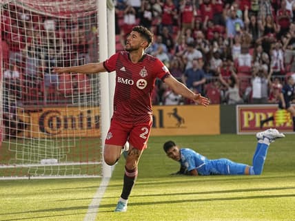 Jun 25, 2022; Toronto, Ontario, CAN; Toronto FC midfielder Jonathan Osorio (21) celebrates after scoring a goal against Atlanta United FC goalkeeper Rocco Rios Novo (34) during the first half at BMO Field. Mandatory Credit: John E. Sokolowski-USA TODAY Sports