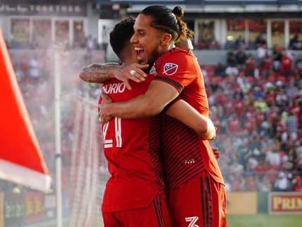 Jun 25, 2022; Toronto, Ontario, CAN;  Toronto FC midfielder Jonathan Osorio (21) celebrates with defender Carlos Salcedo (3) after scoring a goal against Atlanta United FC during the first half at BMO Field. Mandatory Credit: John E. Sokolowski-USA TODAY Sports