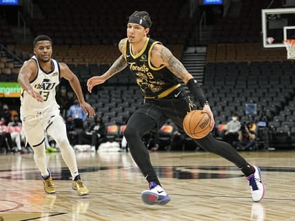 Jan 7, 2022; Toronto, Ontario, CAN; Toronto Raptors forward D.J. Wilson (9) drives to he net against Utah Jazz guard Jared Butler (13) during the second half at Scotiabank Arena. Mandatory Credit: John E. Sokolowski-USA TODAY Sports