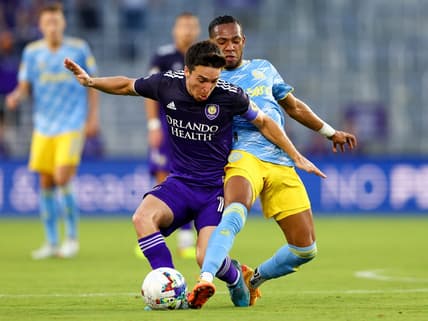 Jul 23, 2022; Orlando, Florida, USA;  Orlando City midfielder Mauricio Pereyra (10) and Philadelphia Union midfielder Jose Andres Martinez (8) battle for possession in the first half at Exploria Stadium. Mandatory Credit: Nathan Ray Seebeck-USA TODAY Sports