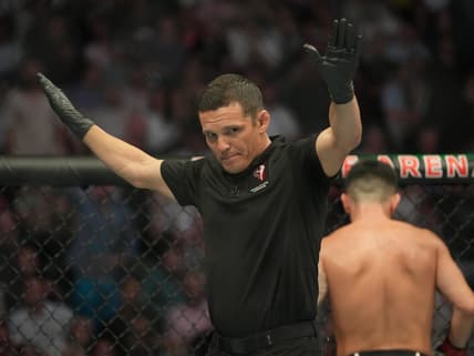 Jul 2, 2022; Las Vegas, Nevada, USA; Ring referee Jason Herzog waves off the fight after Pedro Munhoz (red gloves) was accidentally poked in the eye during the bout against Sean O'Malley (blue gloves) during UFC 276 at T-Mobile Arena. Mandatory Credit: Stephen R. Sylvanie-USA TODAY Sports