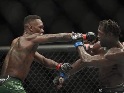 Jul 2, 2022; Las Vegas, Nevada, USA; Israel Adesanya (red gloves) and Jared Cannonier (blue gloves) fight in a bout during UFC 276 at T-Mobile Arena. Mandatory Credit: Stephen R. Sylvanie-USA TODAY Sports