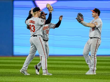 Sep 18, 2022; Toronto, Ontario, CAN; Baltimore Orioles left fielder Kyle Stowers (83) and center fielder Cedric Mullins (31) and right fielder Austin Hays (21) celebrate a win over the Toronto Blue Jays at the end of the ninth inning at Rogers Centre. Mandatory Credit: John E. Sokolowski-USA TODAY Sports