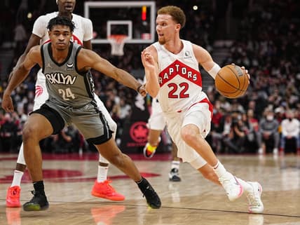 Mar 1, 2022; Toronto, Ontario, CAN; Toronto Raptors guard Malachi Flynn (22) drives to the net against Brooklyn Nets guard Cam Thomas (24) during the second half at Scotiabank Arena. Mandatory Credit: John E. Sokolowski-USA TODAY Sports