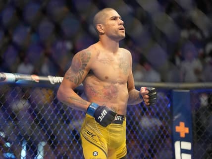 Jul 2, 2022; Las Vegas, Nevada, USA; Alex Pereira (blue gloves) enters the octagon before a bout against Sean Strickland (red gloves) during UFC 276 at T-Mobile Arena. Mandatory Credit: Stephen R. Sylvanie-USA TODAY Sports