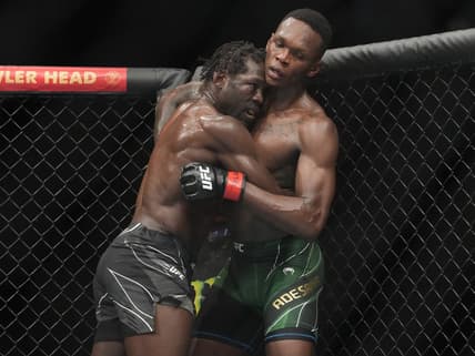 Jul 2, 2022; Las Vegas, Nevada, USA; Israel Adesanya (red gloves) and Jared Cannonier (blue gloves) fight in a bout during UFC 276 at T-Mobile Arena. Mandatory Credit: Stephen R. Sylvanie-USA TODAY Sports