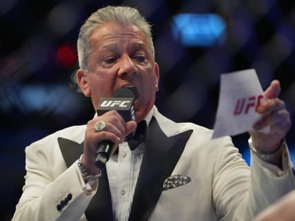 Jul 2, 2022; Las Vegas, Nevada, USA; Ring announcer Bruce Buffer introduces Jessica-Rose Clark (red gloves) and Julija Stoliarenko (blue gloves) before a bout during UFC 276 at T-Mobile Arena. Mandatory Credit: Stephen R. Sylvanie-USA TODAY Sports