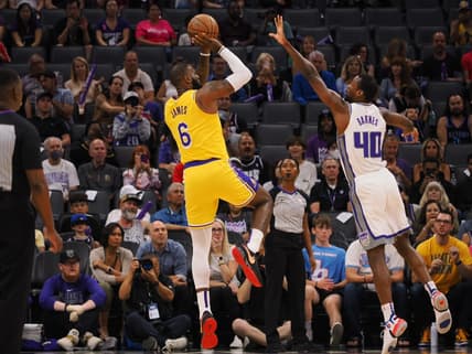 Oct 14, 2022; Sacramento, California, USA; Los Angeles Lakers small forward LeBron James (6) scores a basket against Sacramento Kings power forward Harrison Barnes (40) during the first quarter at Golden 1 Center. Mandatory Credit: Kelley L Cox-USA TODAY Sports