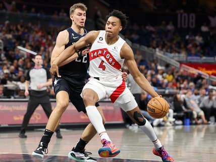 Dec 11, 2022; Orlando, Florida, USA;  Toronto Raptors forward Scottie Barnes (4) drives to the basket past Orlando Magic forward Franz Wagner (22) in the first quarter at Amway Center. Mandatory Credit: Nathan Ray Seebeck-USA TODAY Sports