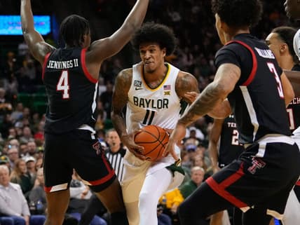 Feb 4, 2023; Waco, Texas, USA;  Baylor Bears forward Jalen Bridges (11) drives to the basket between Texas Tech Red Raiders forward Robert Jennings (4) and guard D'Maurian Williams (3) during the first half at Ferrell Center. Mandatory Credit: Chris Jones-USA TODAY Sports