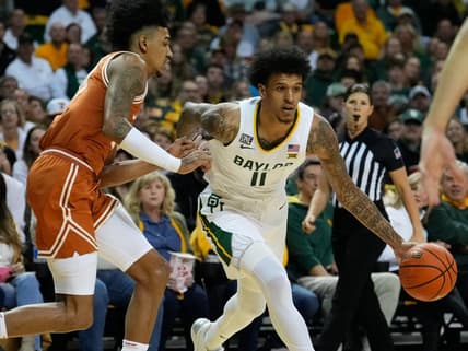 Feb 25, 2023; Waco, Texas, USA;  Baylor Bears forward Jalen Bridges (11) controls the ball as Texas Longhorns forward Dillon Mitchell (23) defends during the first half at Ferrell Center. Mandatory Credit: Chris Jones-USA TODAY Sports