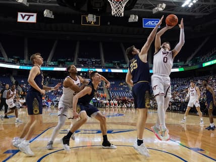 Mar 7, 2023; Greensboro, NC, USA; Virginia Tech Hokies guard Hunter Cattoor (0) takes a shot over Notre Dame Fighting Irish forward Matt Zona (25) during the first half of the first round of the ACC tournament at Greensboro Coliseum. Mandatory Credit: John David Mercer-USA TODAY Sports