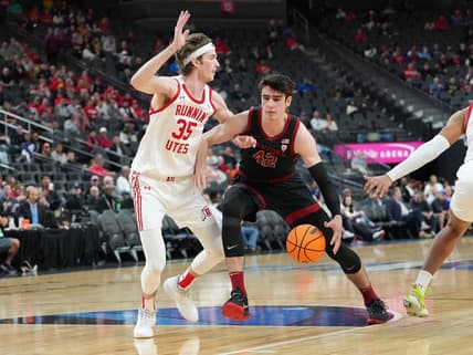 Mar 8, 2023; Las Vegas, NV, USA; Stanford Cardinal forward Maxime Raynaud (42) dribbles against Utah Utes center Branden Carlson (35) during the first half at T-Mobile Arena. Mandatory Credit: Stephen R. Sylvanie-USA TODAY Sports