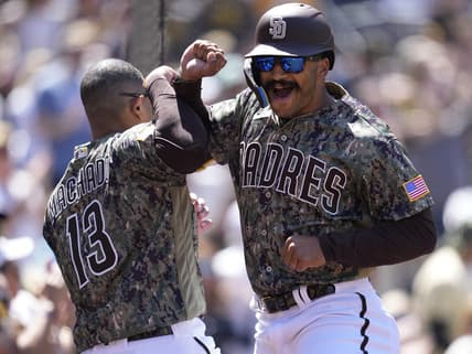 Apr 2, 2023; San Diego, California, USA;  San Diego Padres center fielder Trent Grisham (right) celebrates his home run with third baseman Manny Machado (13) against the Colorado Rockies during the first inning at Petco Park. Mandatory Credit: Ray Acevedo-USA TODAY Sports