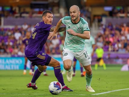 May 27, 2023; Orlando, Florida, USA;  Orlando City SC defender Kyle Smith (24) and Atlanta United FC defender Andrew Gutman (15) fight for possession in the first half at Exploria Stadium. Mandatory Credit: Nathan Ray Seebeck-USA TODAY Sports