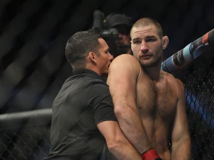 Jul 2, 2022; Las Vegas, Nevada, USA; Sean Strickland (red gloves) reacts after a loss to Alex Pereira (blue gloves) fight in a bout during UFC 276 at T-Mobile Arena. Mandatory Credit: Stephen R. Sylvanie-USA TODAY Sports