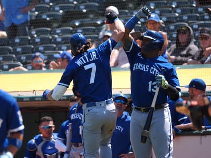 Aug 23, 2023; Oakland, California, USA; Kansas City Royals shortstop Bobby Witt Jr. (7) celebrates with first baseman Salvador Perez (13) after hitting a solo home run against the Oakland Athletics during the fifth inning at Oakland-Alameda County Coliseum. Mandatory Credit: Kelley L Cox-USA TODAY Sports
