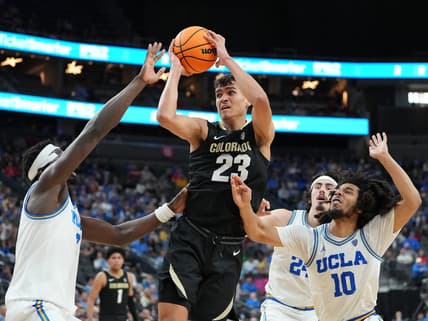 Mar 9, 2023; Las Vegas, NV, USA; Colorado Buffaloes forward Tristan da Silva (23) looks to shoot between UCLA Bruins forward Adem Bona (3) and guard Tyger Campbell (10) during the second half at T-Mobile Arena. Mandatory Credit: Stephen R. Sylvanie-USA TODAY Sports