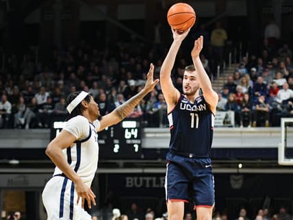 Jan 5, 2024; Indianapolis, Indiana, USA; Connecticut Huskies forward Alex Karaban (11) attempts a shot over Butler Bulldogs forward Jalen Thomas (1) during the second half at Hinkle Fieldhouse. Mandatory Credit: Robert Goddin-USA TODAY Sports