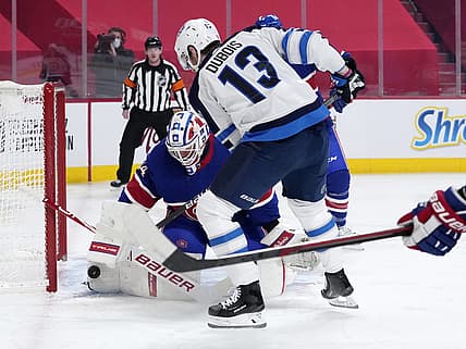 Mar 4, 2021; Montreal, Quebec, CAN; Montreal Canadiens goalie Jake Allen (34) stops a shot by Winnipeg Jets forward Pierre-Luc Dubois (13) during the first period at the Bell Centre. Mandatory Credit: Eric Bolte-USA TODAY Sports