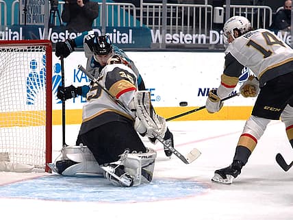 Mar 5, 2021; San Jose, California, USA; Vegas Golden Knights goalie Oscar Dansk (35) and defenseman Nicolas Hague (14) defend the goal against San Jose Sharks Joel Kellman (46) during the first period at SAP Center at San Jose. Mandatory Credit: Kelley L Cox-USA TODAY Sports