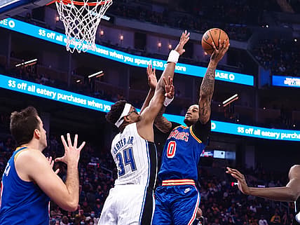 Dec 6, 2021; San Francisco, California, USA; Golden State Warriors guard Gary Payton II (0) scores a basket against Orlando Magic center-forward Wendell Carter Jr (34) during the second quarter at Chase Center. Mandatory Credit: Kelley L Cox-USA TODAY Sports