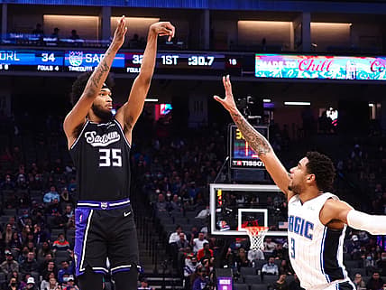 Dec 8, 2021; Sacramento, California, USA; Sacramento Kings forward Marvin Bagley III (35) scores a three point basket against Orlando Magic forward Chuma Okeke (3) during the first quarter at Golden 1 Center. Mandatory Credit: Kelley L Cox-USA TODAY Sports