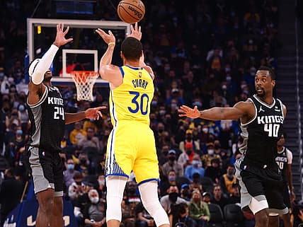 Dec 20, 2021; San Francisco, California, USA; Sacramento Kings guard Buddy Hield (24) and forward Harrison Barnes (40) defend Golden State Warriors guard Stephen Curry (30) on a shot during the first quarter at Chase Center. Mandatory Credit: Kelley L Cox-USA TODAY Sports