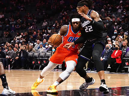 Dec 28, 2021; Sacramento, California, USA; Oklahoma City Thunder guard Luguentz Dort (5) drives in agaisnt Sacramento Kings forward Richaun Holmes (22) during the first quarter at Golden 1 Center. Mandatory Credit: Kelley L Cox-USA TODAY Sports