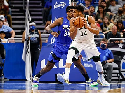Dec 30, 2021; Orlando, Florida, USA; Milwaukee Bucks forward Giannis Antetokounmpo (34) drives the ball past Orlando Magic center Wendell Carter Jr. (34) in the second quarter at Amway Center. Mandatory Credit: Nathan Ray Seebeck-USA TODAY Sports