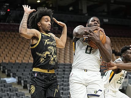 Jan 7, 2022; Toronto, Ontario, CAN; Toronto Raptors forward Justin Champagnie (11) avoids contacting Utah Jazz forward Eric Paschall (0) after a rebound during the first half at Scotiabank Arena. Mandatory Credit: John E. Sokolowski-USA TODAY Sports