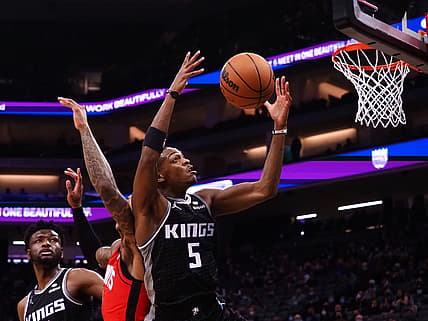 Jan 16, 2022; Sacramento, California, USA; Sacramento Kings guard De'Aaron Fox (5) controls a rebound against the Houston Rockets during the second quarter at Golden 1 Center. Mandatory Credit: Kelley L Cox-USA TODAY Sports