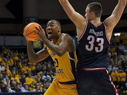 Feb 24, 2022; Murray, Kentucky, USA;  Murray State Racers forward KJ Williams (0) drives past Belmont Bruins center Nick Muszynski (33) during the second half at CFSB Center. Mandatory Credit: Steve Roberts-USA TODAY Sports
