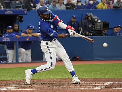Jun 27, 2022; Toronto, Ontario, CAN; Toronto Blue Jays right fielder Teoscar Hernandez (37) hits a single against the Boston Red Sox during the third inning at Rogers Centre. Mandatory Credit: John E. Sokolowski-USA TODAY Sports