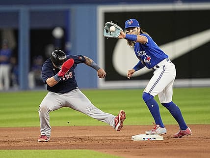 Jun 27, 2022; Toronto, Ontario, CAN; Boston Red Sox catcher Christian Vazquez (7) goes back to second against Toronto Blue Jays shortstop Bo Bichette (11) can make a tag during the seventh inning at Rogers Centre. Mandatory Credit: John E. Sokolowski-USA TODAY Sports