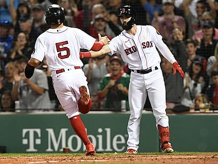 Sep 2, 2022; Boston, Massachusetts, USA; Boston Red Sox center fielder Enrique Hernandez (5) celebrates with catcher Connor Wong (74) after scoring a run against the Texas Rangers during the fourth inning at Fenway Park. Mandatory Credit: Brian Fluharty-USA TODAY Sports