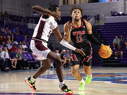 Nov 23, 2022; Fort Myers, Florida, USA;  Utah Utes guard Wilguens Exacte Jr. (11) drives to the hoop past Mississippi State Bulldogs forward Kimani Hamilton (5) in the first half during the Fort Myers Tip-Off Beach Division championship game at Suncoast Credit Union Arena. Mandatory Credit: Nathan Ray Seebeck-USA TODAY Sports