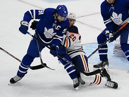 Jan 22, 2021; Toronto, Ontario, CAN; Edmonton Oilers defenceman Slater Koekkoek (20) defends against Toronto Maple Leafs forward John Tavares (91) during the second period at Scotiabank Arena. Mandatory Credit: John E. Sokolowski-USA TODAY Sports