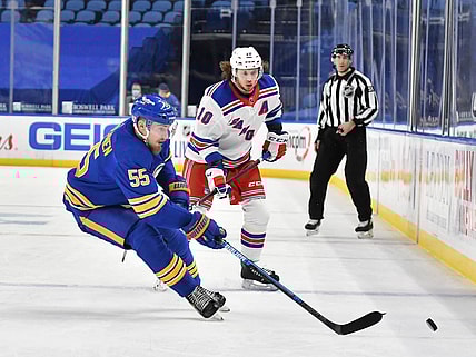 Jan 26, 2021; Buffalo, New York, USA; Buffalo Sabres defenseman Rasmus Ristolainen (55) controls the puck in front of New York Rangers left wing Artemi Panarin (10) in the third period at KeyBank Center. Mandatory Credit: Mark Konezny-USA TODAY Sports