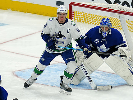 Feb 4, 2021; Toronto, Ontario, CAN; Vancouver Canucks forward Bo Horvat (53) tries to screen Toronto Maple Leafs goaltender Frederik Andersen (31) at Scotiabank Arena. Mandatory Credit: John E. Sokolowski-USA TODAY Sports