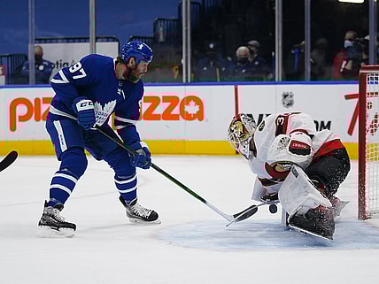 Feb 17, 2021; Toronto, Ontario, CAN; Ottawa Senators goaltender Matt Murray (30) makes a save on a shot by Toronto Maple Leafs forward Joe Thornton (97) during the first period at Scotiabank Arena. Mandatory Credit: John E. Sokolowski-USA TODAY Sports
