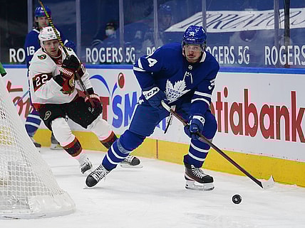Feb 17, 2021; Toronto, Ontario, CAN; Toronto Maple Leafs forward Auston Matthews (34) skates past Ottawa Senators defenseman Nikita Zaitsev (22) during the third period at Scotiabank Arena. Mandatory Credit: John E. Sokolowski-USA TODAY Sports