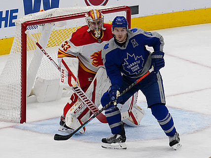 Feb 24, 2021; Toronto, Ontario, CAN; Toronto Maple Leafs forward Zach Hyman (11) screens Calgary Flames goaltender David Rittich (33) during the first period at Scotiabank Arena. Mandatory Credit: John E. Sokolowski-USA TODAY Sports
