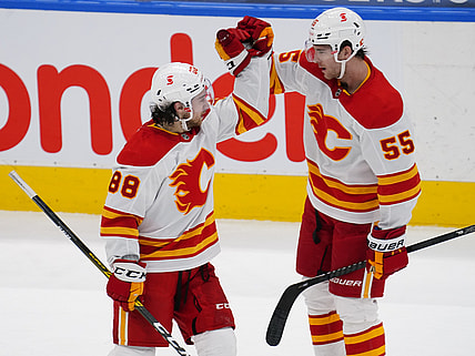 Feb 24, 2021; Toronto, Ontario, CAN; Calgary Flames forward Andrew Mangiapane (88) celebrates his goal against the Toronto Maple Leafs with Calgary Flames defenseman Noah Hanifin (55) during the third period at Scotiabank Arena. Mandatory Credit: John E. Sokolowski-USA TODAY Sports