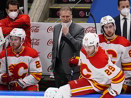Feb 24, 2021; Toronto, Ontario, CAN; Calgary Flames head coach Geoff Ward (center) on the bench against the Toronto Maple Leafs during the first period at Scotiabank Arena. Mandatory Credit: John E. Sokolowski-USA TODAY Sports