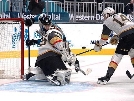 Mar 5, 2021; San Jose, California, USA; Vegas Golden Knights goalie Oscar Dansk (35) and defenseman Nicolas Hague (14) defend the goal against San Jose Sharks Joel Kellman (46) during the first period at SAP Center at San Jose. Mandatory Credit: Kelley L Cox-USA TODAY Sports